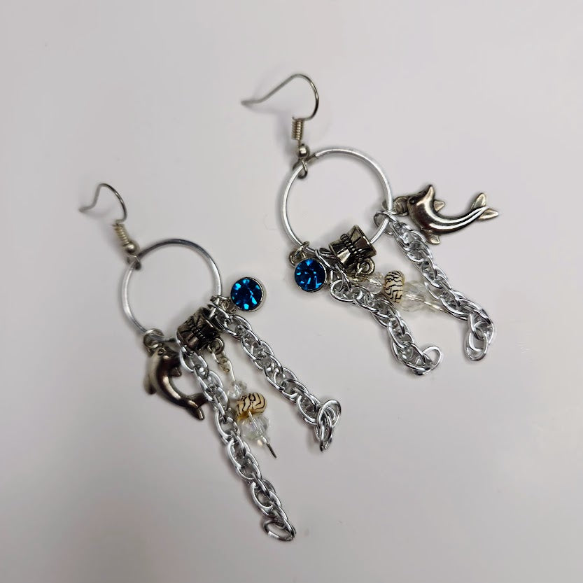 Handcrafted Charm Earrings In Silver Color With Shells, Dolphin and Blue Crystal Charms
