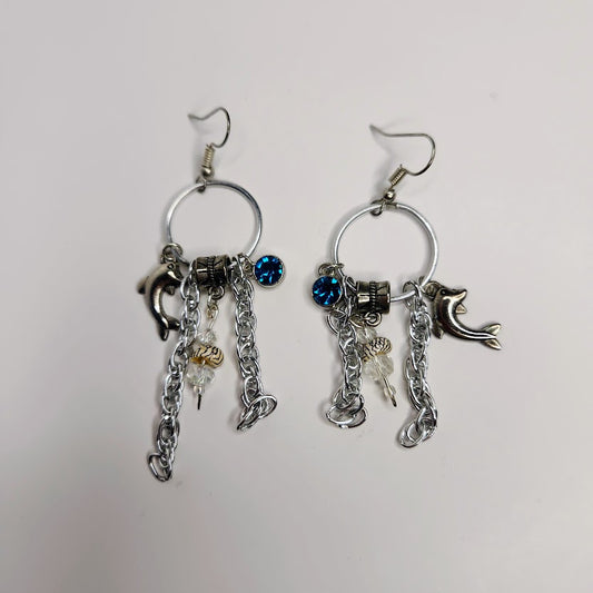 Handcrafted Charm Earrings In Silver Color With Shells, Dolphin and Blue Crystal Charms