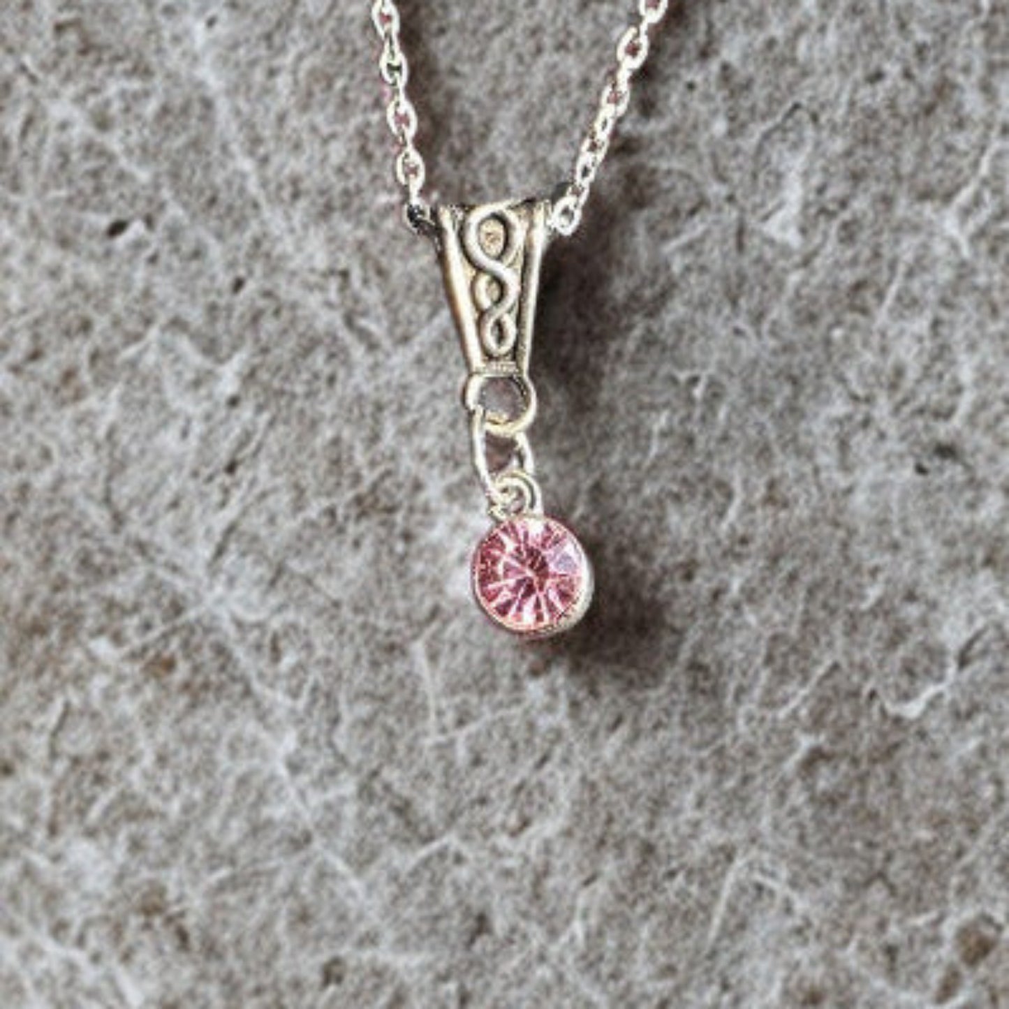 Handmade silver-plated crystal pendant necklace with an 18-inch silver-tone chain on marble grey