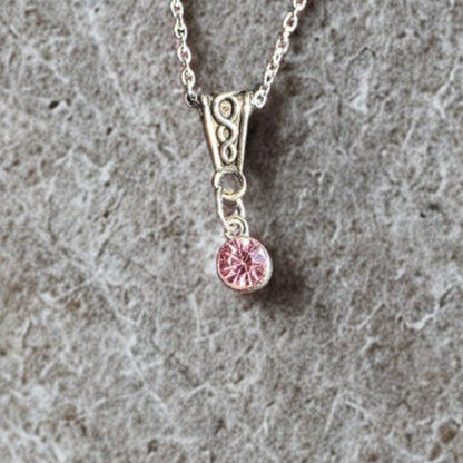 Handmade silver-plated crystal pendant necklace with an 18-inch silver-tone chain on marble grey