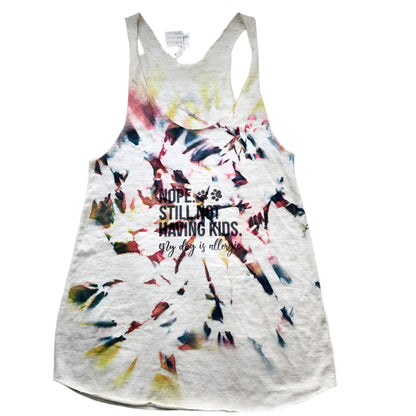 Hand-dyed multicolor small tank top with text on it laid out on a flat surface.