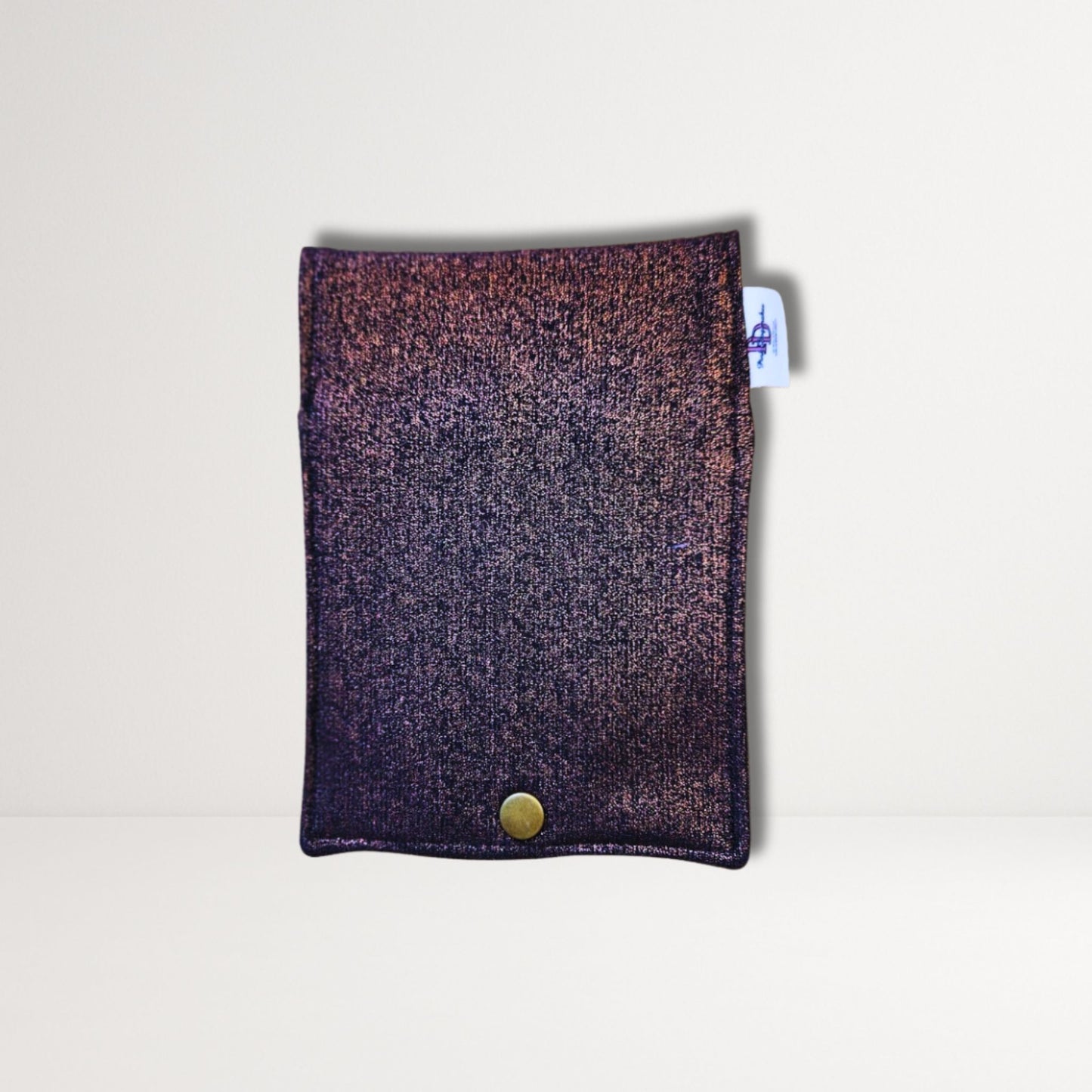 Textured fabric pouch with a button on a light gray background