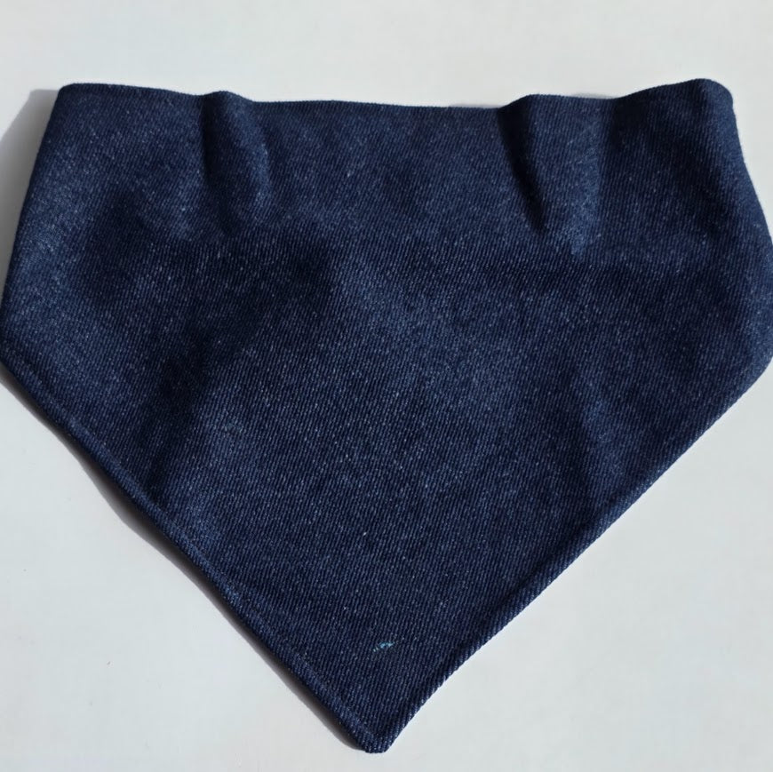 A dark navy blue woven fabric bandana or pet bandana laid flat on a light gray background.
