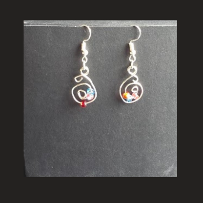 Shop handmade silver-tone spiral dangle earrings with colourful bead accents. Lightweight handcrafted earrings made in Alberta, Canada.