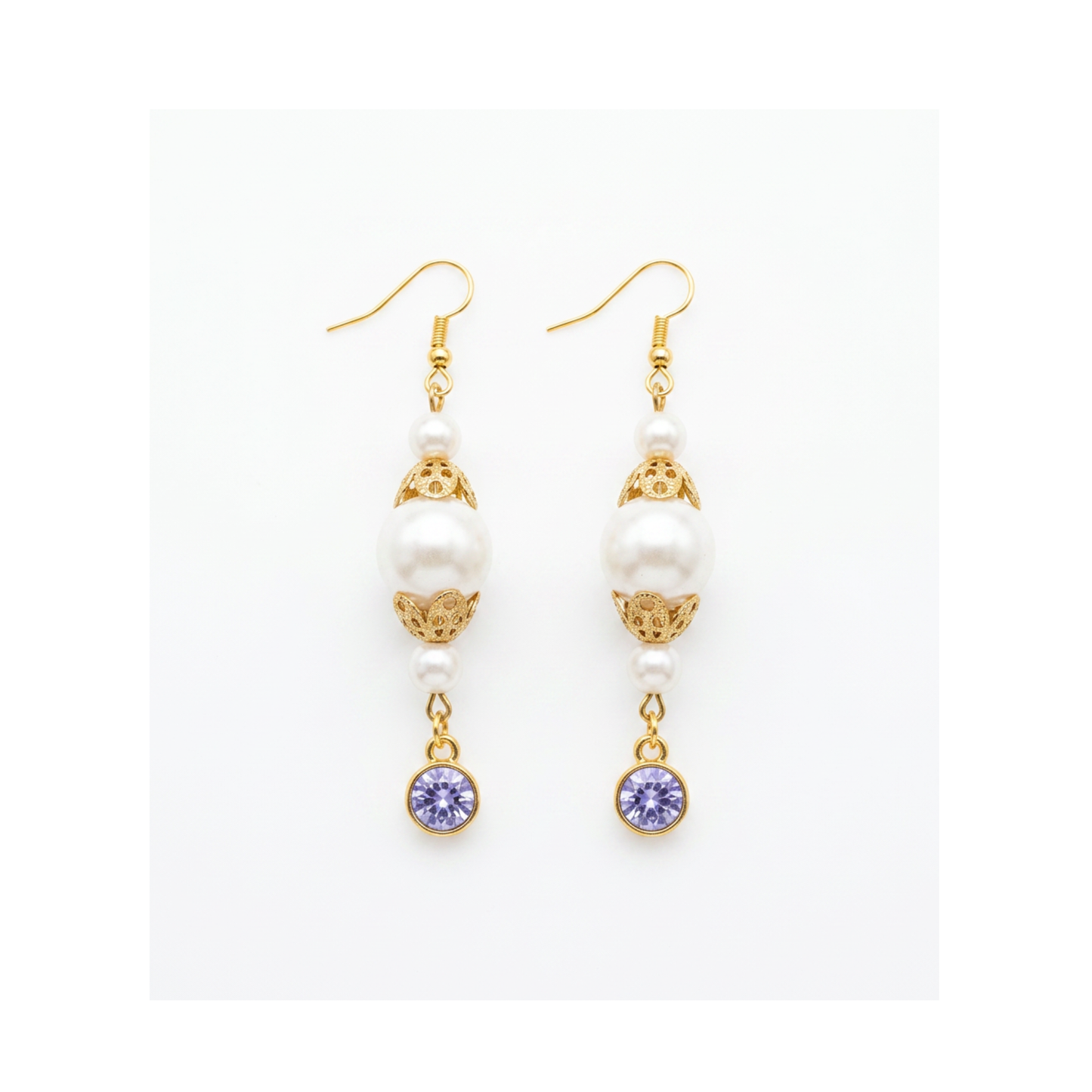 A pair of gold and white drop earrings with white pearl-like beads, ornate gold filigree, and round purple gemstone dangles, shown on a plain white background.