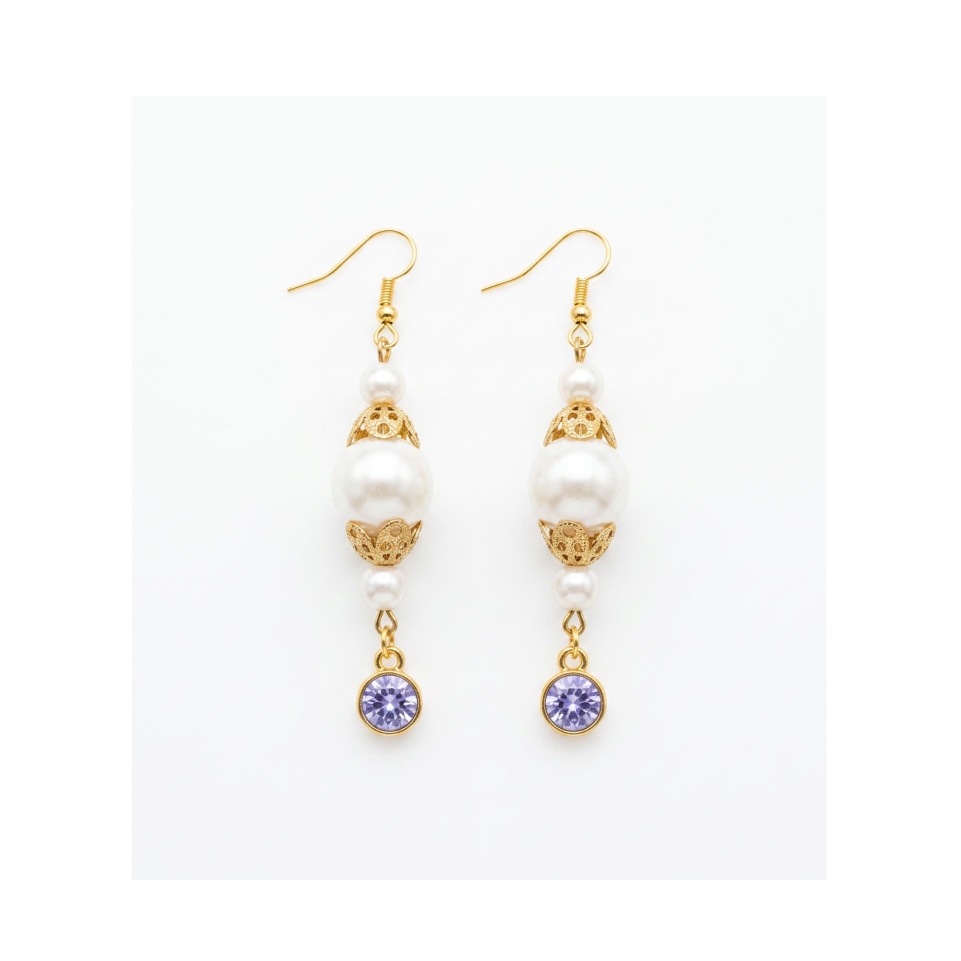 A pair of gold and white drop earrings with white pearl-like beads, ornate gold filigree, and round purple gemstone dangles, shown on a plain white background.