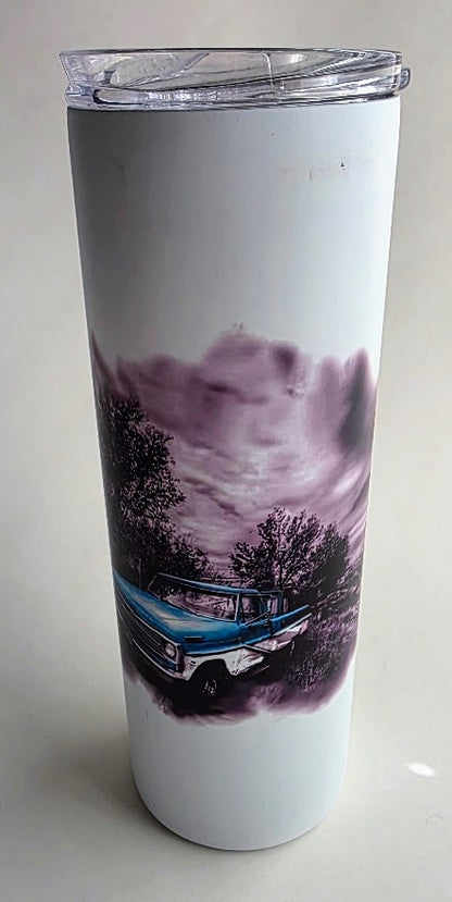 A white insulated travel tumbler with a clear plastic lid, featuring a printed graphic of a blue classic car in a moody purple and black landscape.