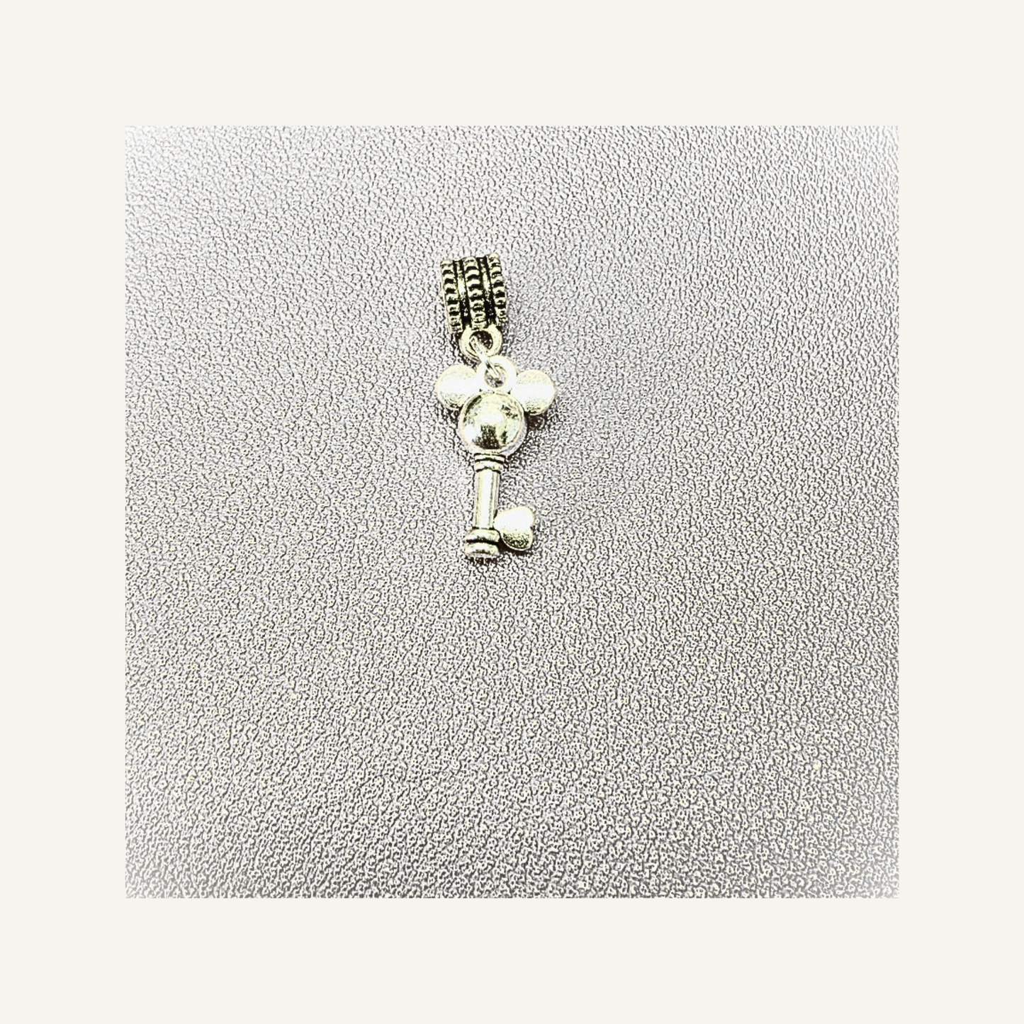 A silver  Mouse-shaped key charm pendant displayed on a textured light gray background.